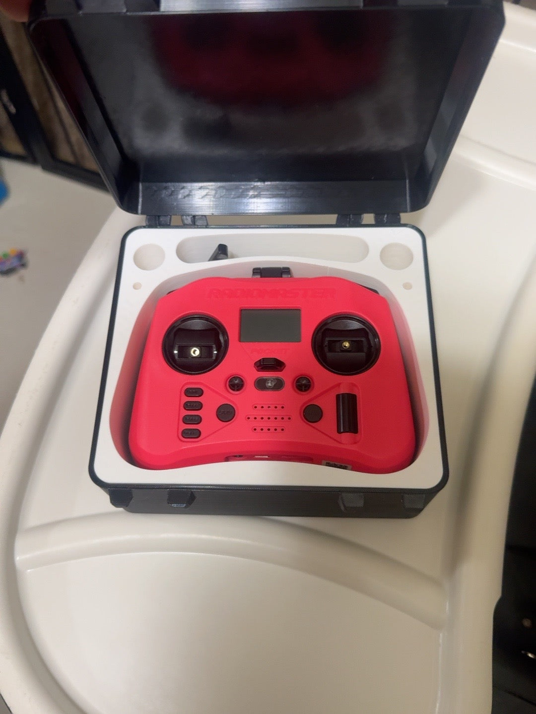 Open white interior with RadioMaster Pocket controller shown for demonstration, controller not included
