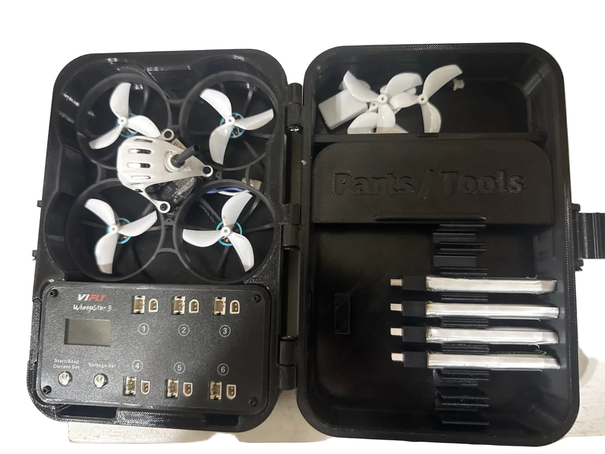 Actual open SkyShell FPV 3D printed Meteor75 carrying case showing custom drone and VIFLY WhoopStor 3 charger compartments, four batteries and accessory storage